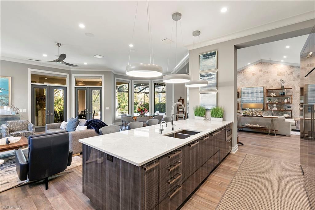 927 Barcarmil Way Naples, FL 34110 - Photo 14 of 48 a large white kitchen with a large window and couch