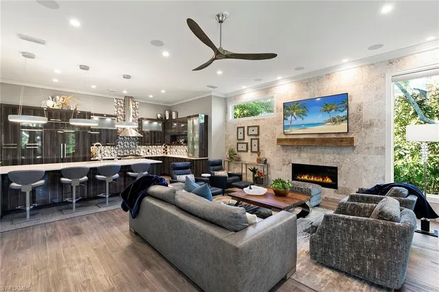 a living room with fireplace furniture and a wooden floor