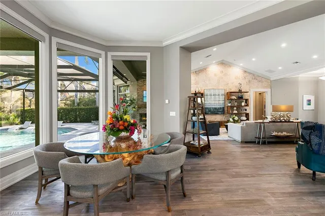 a living room filled with furniture and floor to ceiling windows