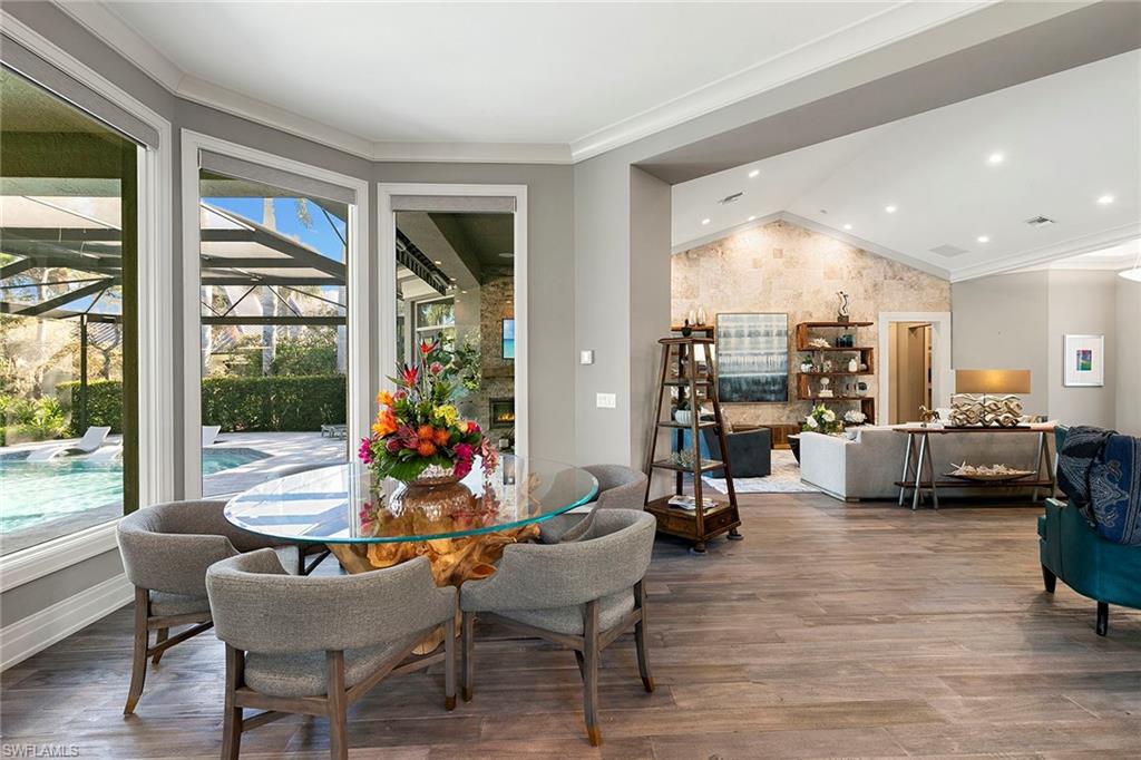 927 Barcarmil Way Naples, FL 34110 - Photo 18 of 48 a living room filled with furniture and floor to ceiling windows