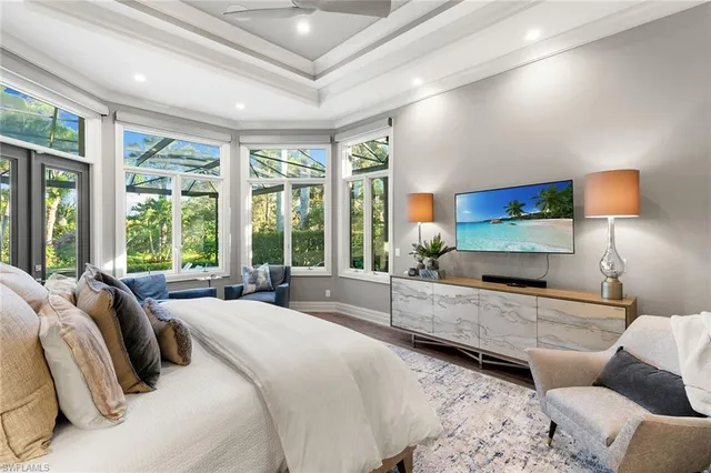 a large bedroom with a bed and large window