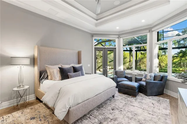 a bedroom with bed and large windows