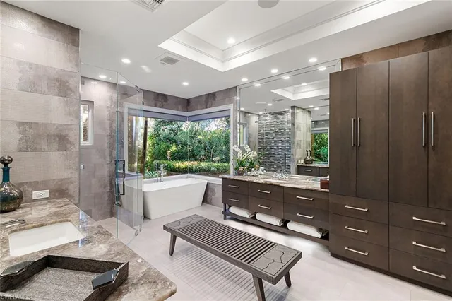 a large living room with a bed furniture and a window