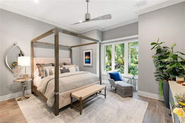 a bed room with a bed and a potted plant