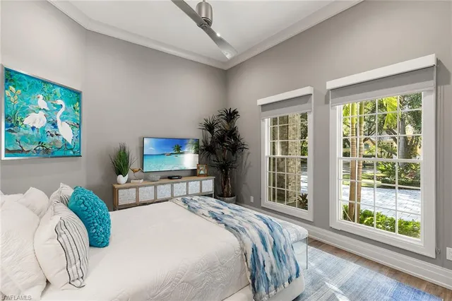 a bedroom with a bed and a large window