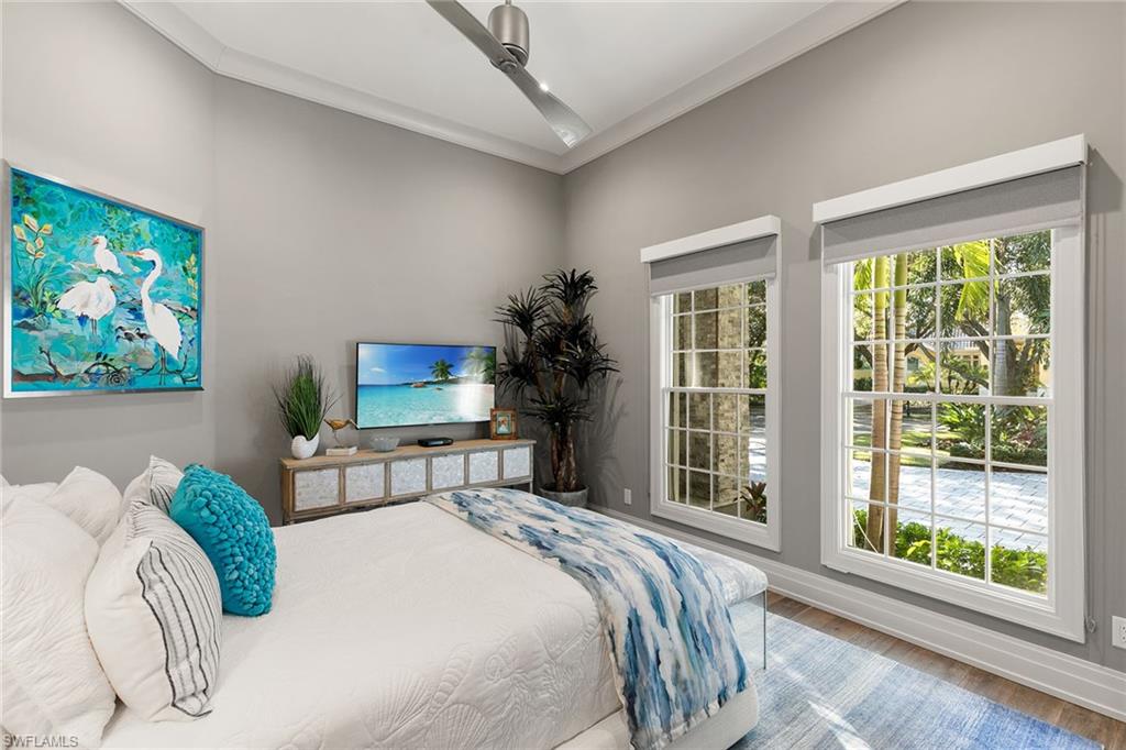927 Barcarmil Way Naples, FL 34110 - Photo 28 of 48 a bedroom with a bed and a large window