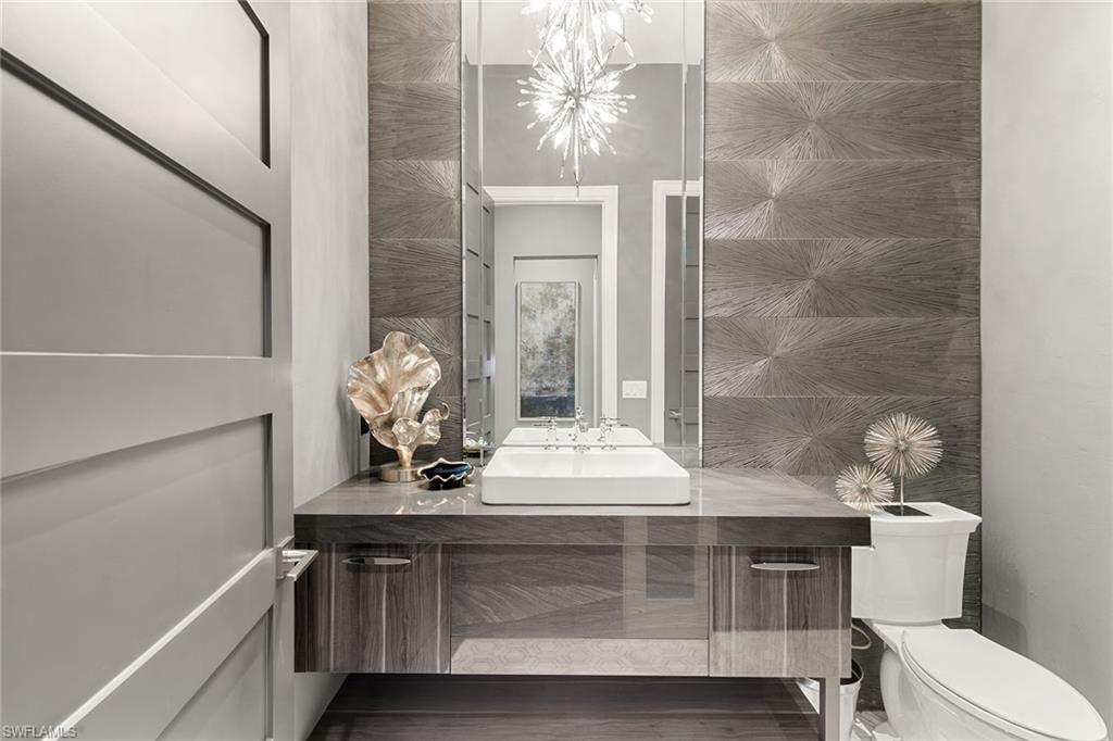 927 Barcarmil Way Naples, FL 34110 - Photo 27 of 50 Bathroom with vanity and tile walls