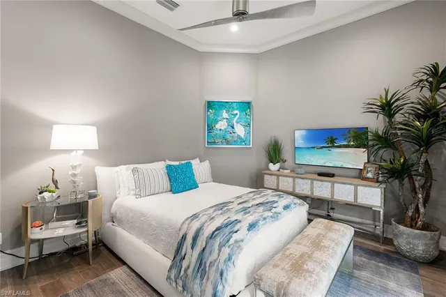 a bedroom with a bed and a potted plant