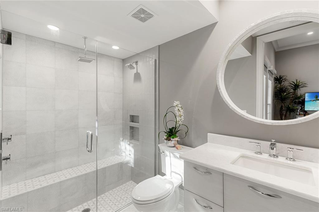 927 Barcarmil Way Naples, FL 34110 - Photo 30 of 48 a bathroom with a sink a toilet and shower