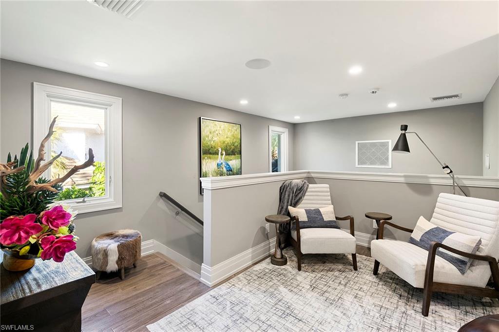 927 Barcarmil Way Naples, FL 34110 - Photo 33 of 50 Living area with an upstairs landing, light wood finished floors, and recessed lighting