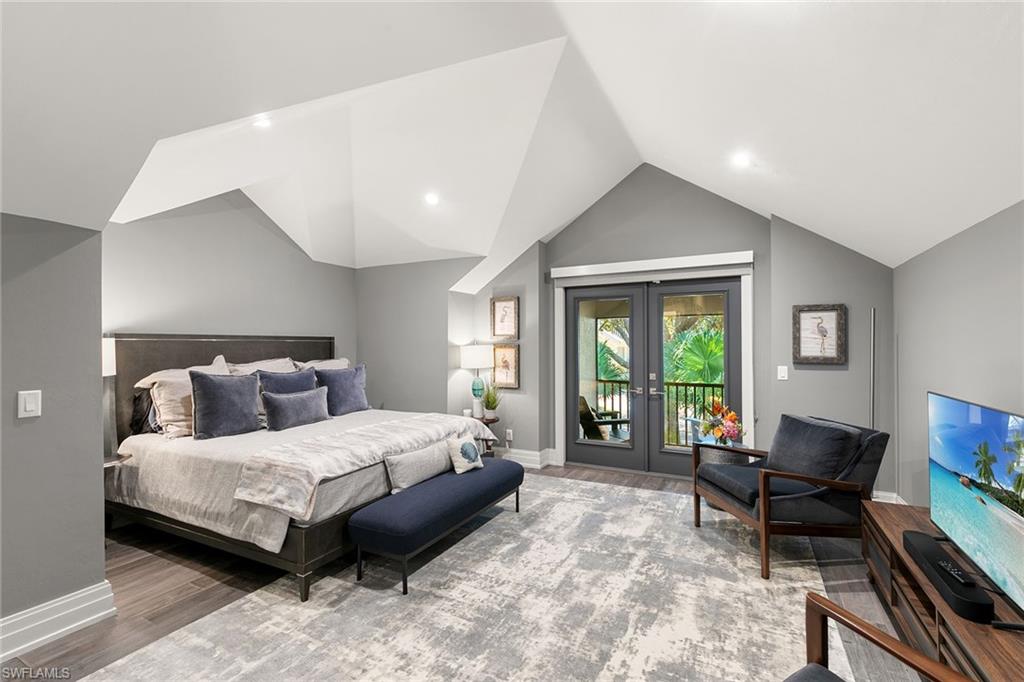 927 Barcarmil Way Naples, FL 34110 - Photo 34 of 50 Bedroom featuring french doors, access to outside, and wood finished floors