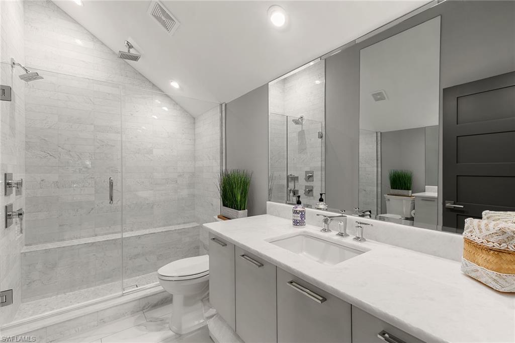 927 Barcarmil Way Naples, FL 34110 - Photo 35 of 48 a bathroom with a sink a toilet and shower