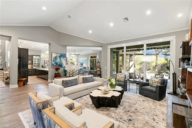 a living room with fireplace furniture and a large window