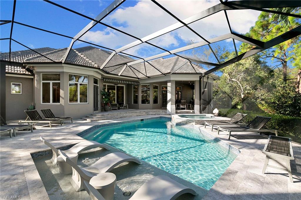 927 Barcarmil Way Naples, FL 34110 - Photo 43 of 50 Combined pool / hot tub featuring a sunroom, a lanai, and a patio area