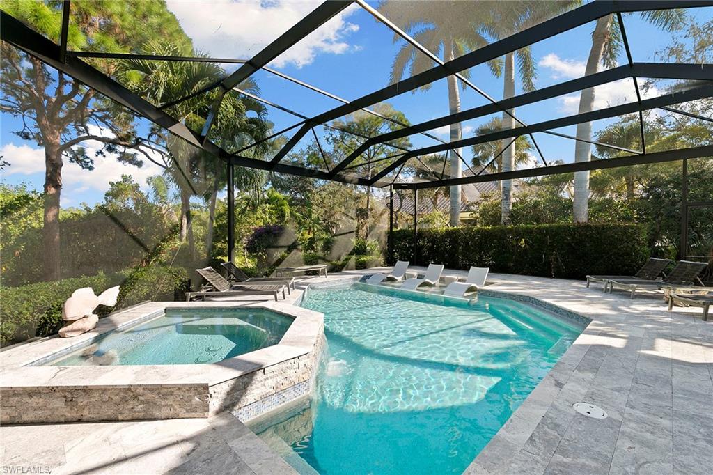 927 Barcarmil Way Naples, FL 34110 - Photo 46 of 50 Integrated pool / spa featuring glass enclosure, a patio area, and a sunroom