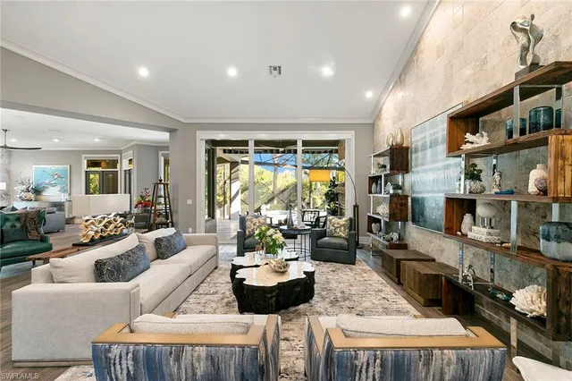a living room with furniture fireplace and a large window