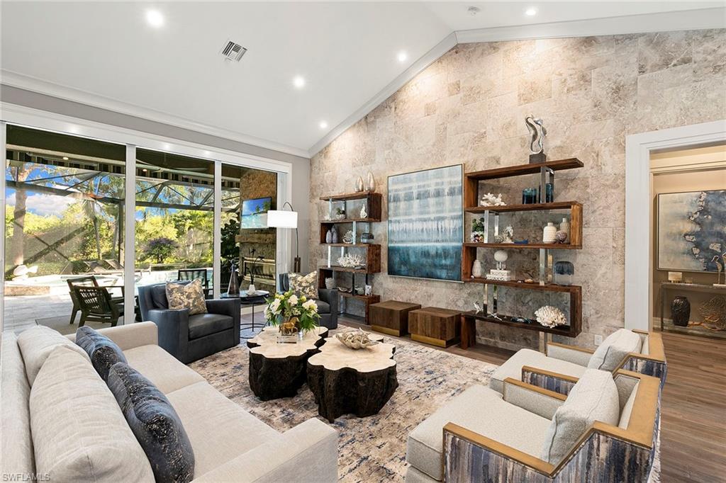 927 Barcarmil Way Naples, FL 34110 - Photo 6 of 48 a living room with furniture and a large window