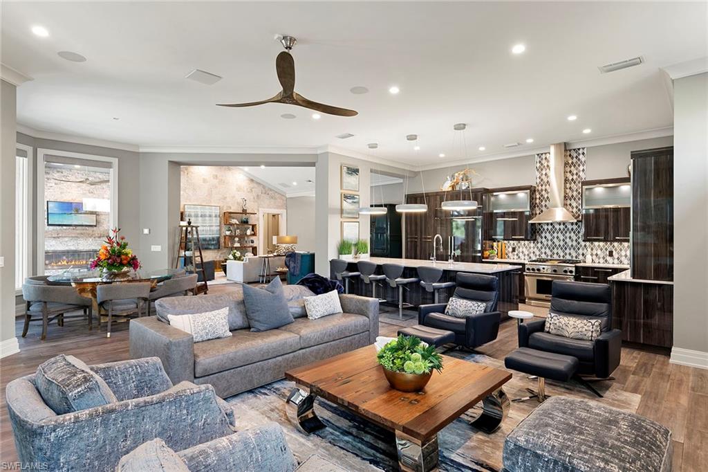 927 Barcarmil Way Naples, FL 34110 - Photo 9 of 50 Living area featuring light wood-style floors, crown molding, ceiling fan, and recessed lighting