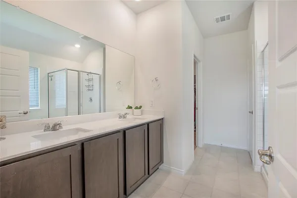 a bathroom with a double vanity sink mirror and