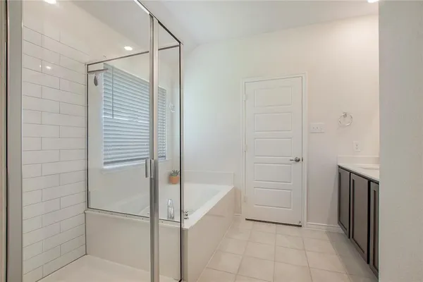 a bathroom with a bathtub and shower