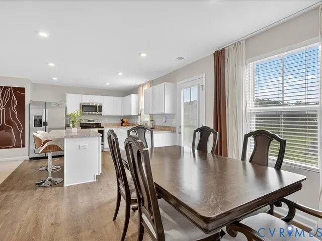 a view of a dining room with furniture and a window