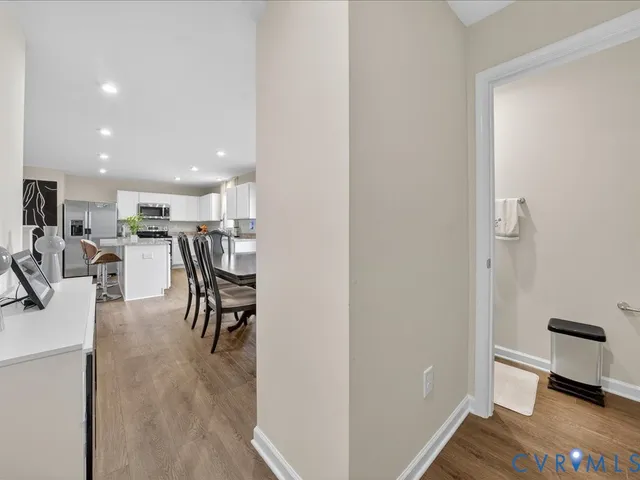 a dining room with furniture and a wooden floor