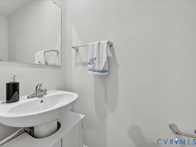 a bathroom with a sink and mirror
