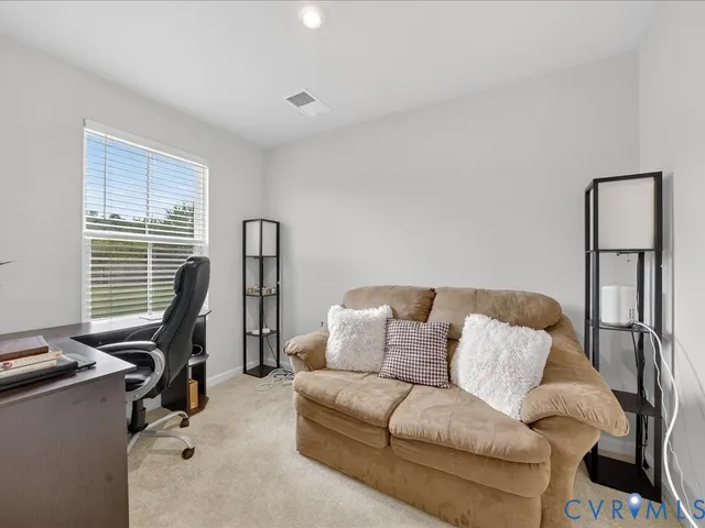 a living room with furniture gym equipment and a window