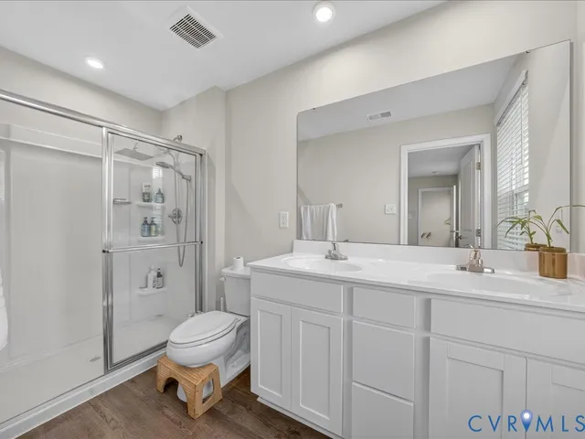 a spacious bathroom with a sink toilet a shower and a mirror