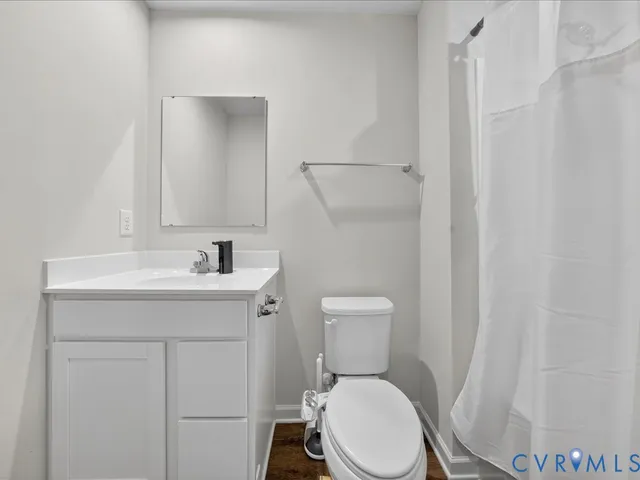 a white toilet sitting next to a bathroom sink