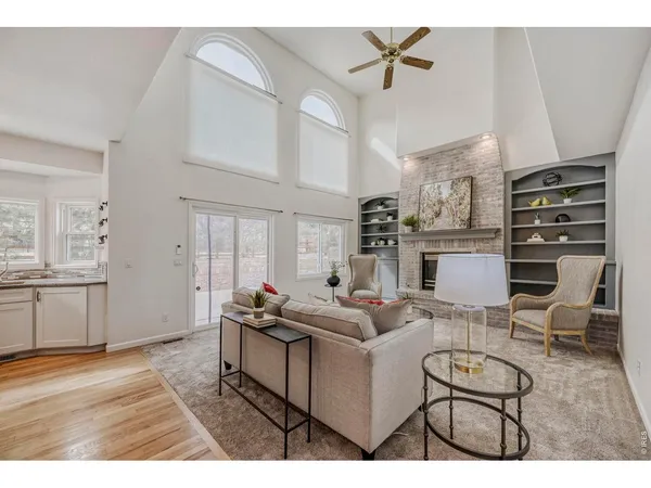 a living room with fireplace furniture and a wooden floor