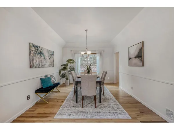 a dining room with furniture a rug and a chandelier