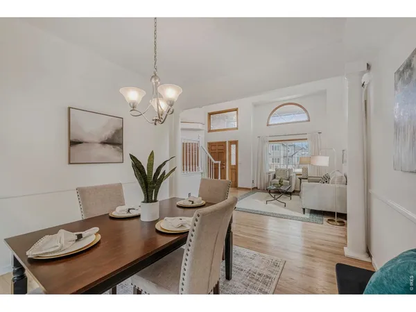 a view of a dining room with furniture and a chandelier