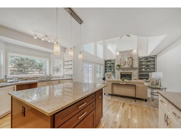 a kitchen with stainless steel appliances granite countertop a sink stove and wooden cabinets