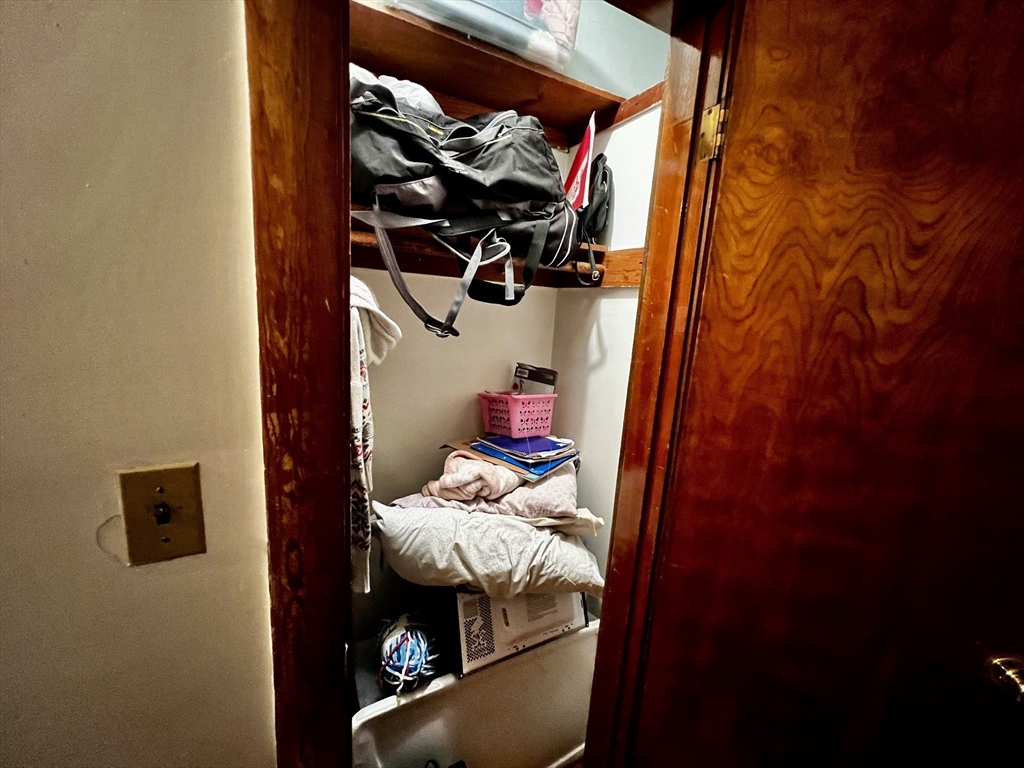 63 Sycamore Street, Unit 2 Somerville, MA 02145 - Photo 7 of 9 a view of walk in closet with clothes and shoes
