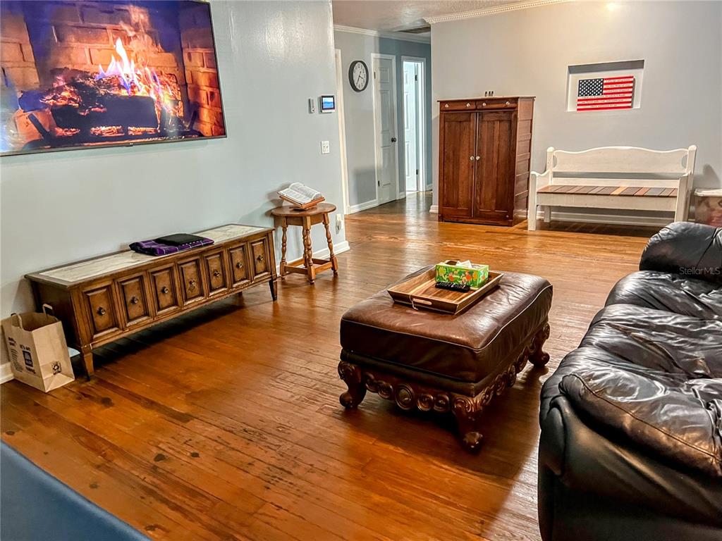 4515 Orangewood Loop East Lakeland, FL 33813 - Photo 12 of 39 a living room with furniture and a dining table with wooden floor