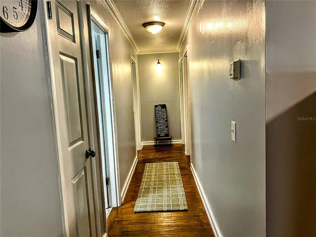 4515 Orangewood Loop East Lakeland, FL 33813 - Photo 13 of 39 a view of a hallway with wooden floor