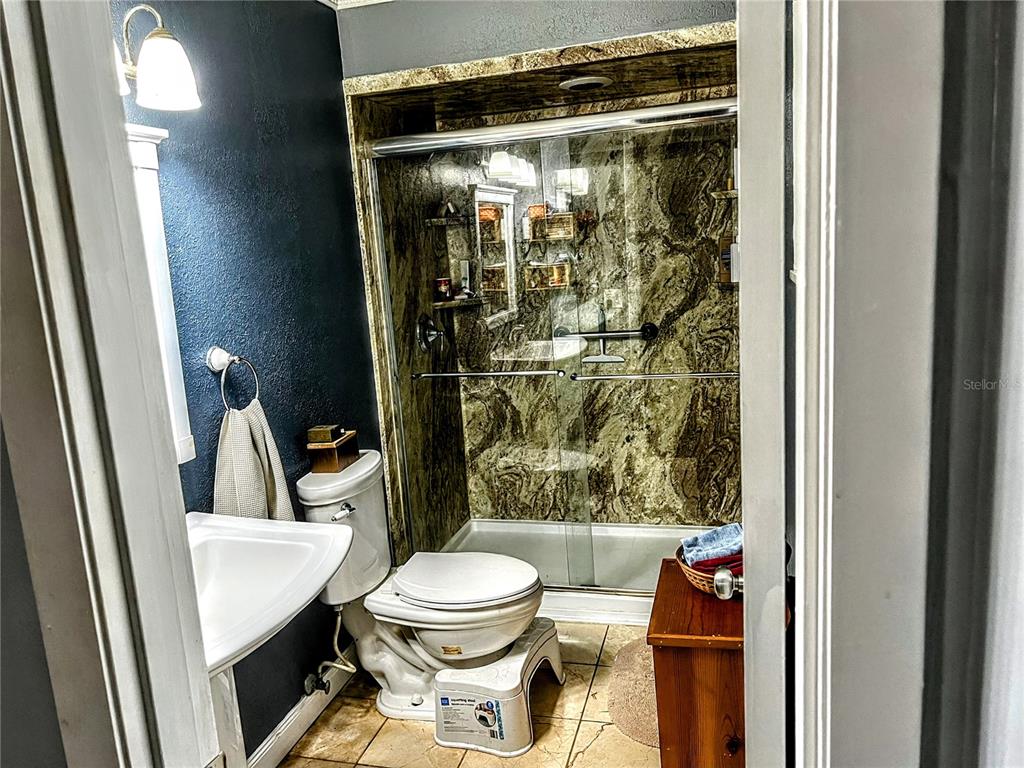 4515 Orangewood Loop East Lakeland, FL 33813 - Photo 20 of 39 a bathroom with a toilet and a shower