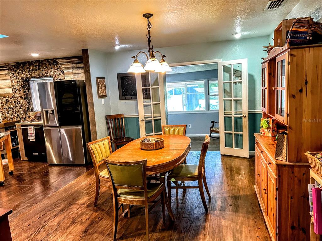 4515 Orangewood Loop East Lakeland, FL 33813 - Photo 21 of 39 a view of a dining room with furniture window and wooden floor