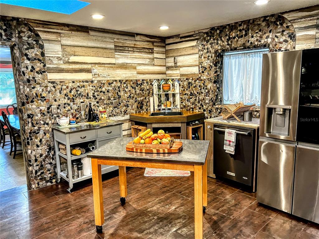 4515 Orangewood Loop East Lakeland, FL 33813 - Photo 24 of 39 a kitchen with stainless steel appliances granite countertop a stove a refrigerator and a refrigerator