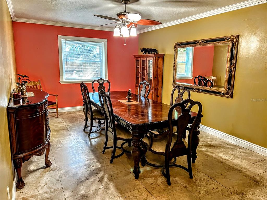 4515 Orangewood Loop East Lakeland, FL 33813 - Photo 26 of 39 a view of a dining room with furniture and a chandelier