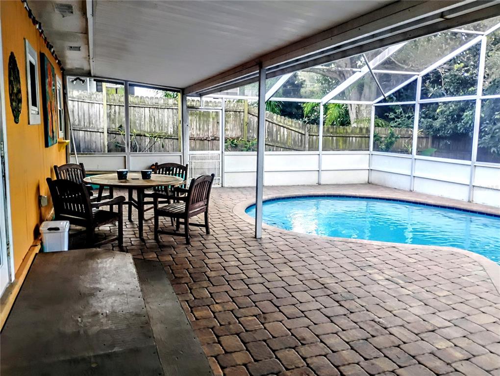4515 Orangewood Loop East Lakeland, FL 33813 - Photo 30 of 39 a view of a dining room with furniture wooden floor and chandelier