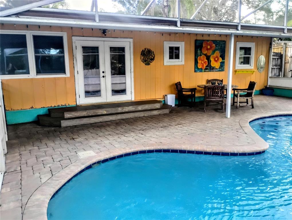 4515 Orangewood Loop East Lakeland, FL 33813 - Photo 31 of 39 a backyard of a house with barbeque oven table and chairs