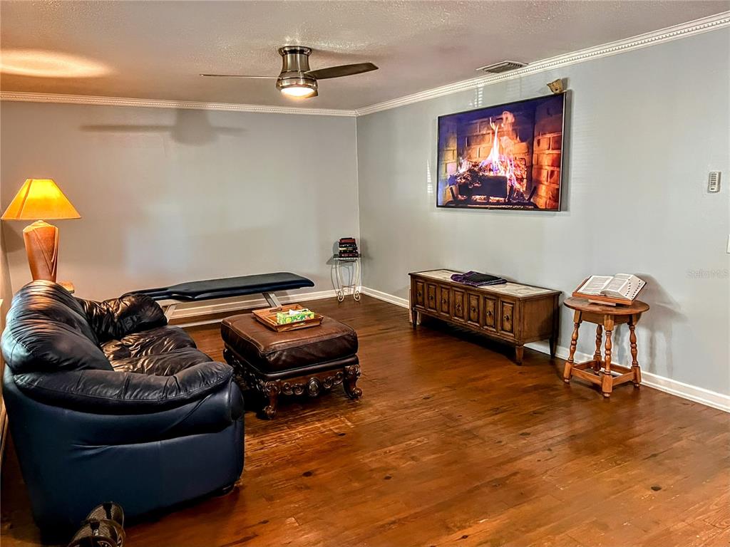 4515 Orangewood Loop East Lakeland, FL 33813 - Photo 10 of 39 a living room with furniture and a flat screen tv