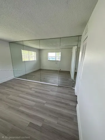 a view of empty room with window and stairs