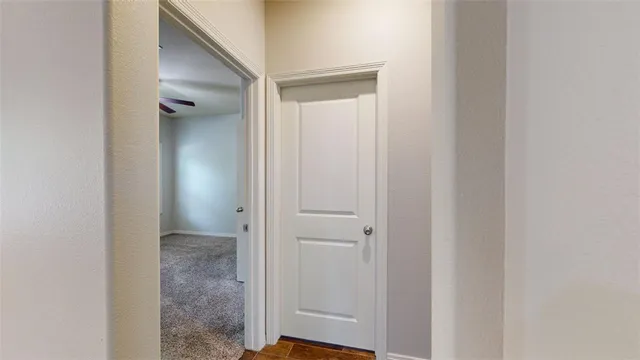 a kitchen with a sink chandelier and wooden floor