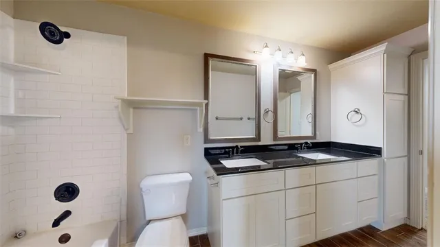 wooden floor in an empty room and a bathroom