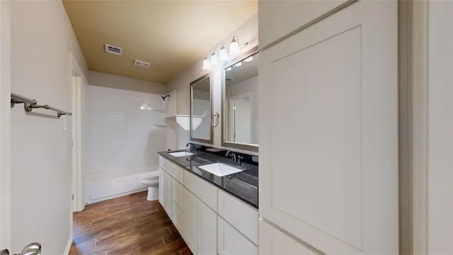 an empty room with closet and a chandelier fan