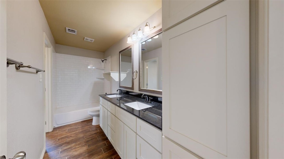 102 Richards Street College Station, TX 77840 - Photo 25 of 41 a kitchen with stainless steel appliances granite countertop a stove and a refrigerator