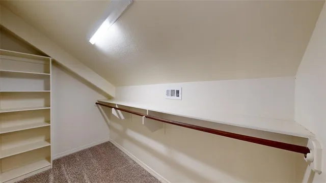 a view of an empty room and a window